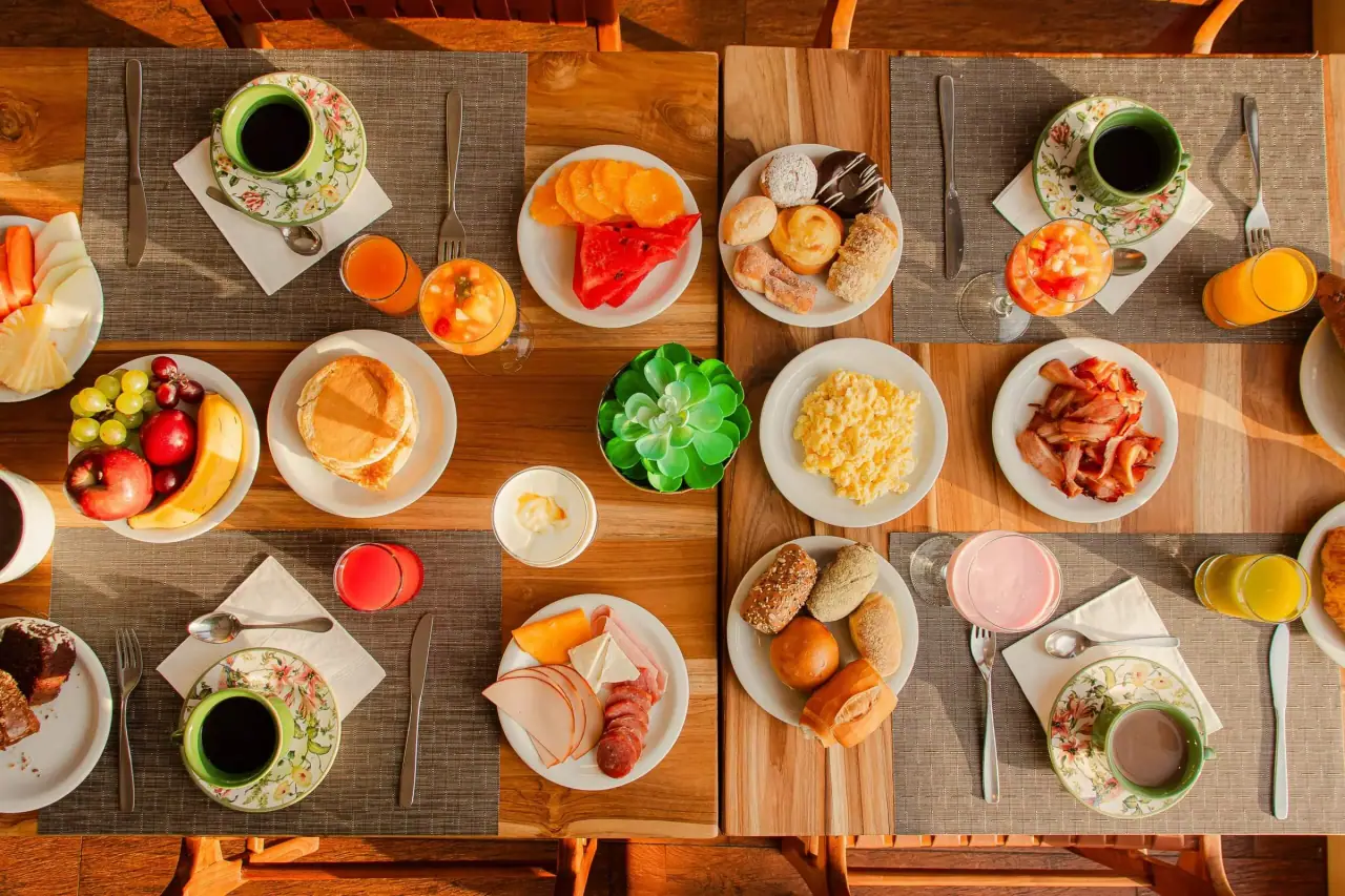 Breakfast table with fruit, bread and juices