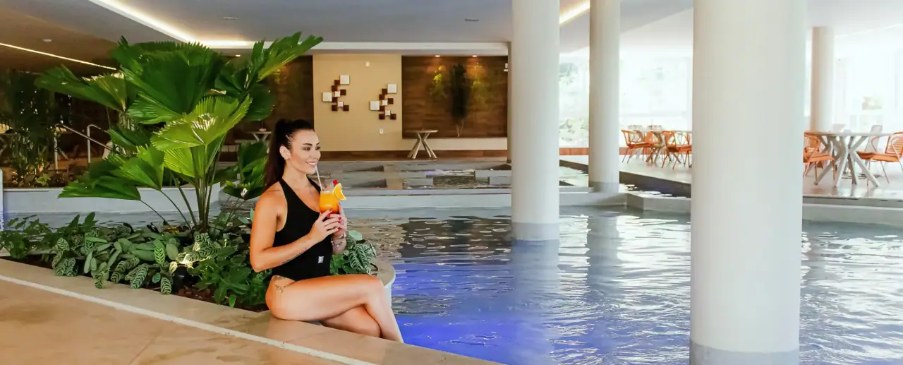 Heated indoor pool with plants and natural light