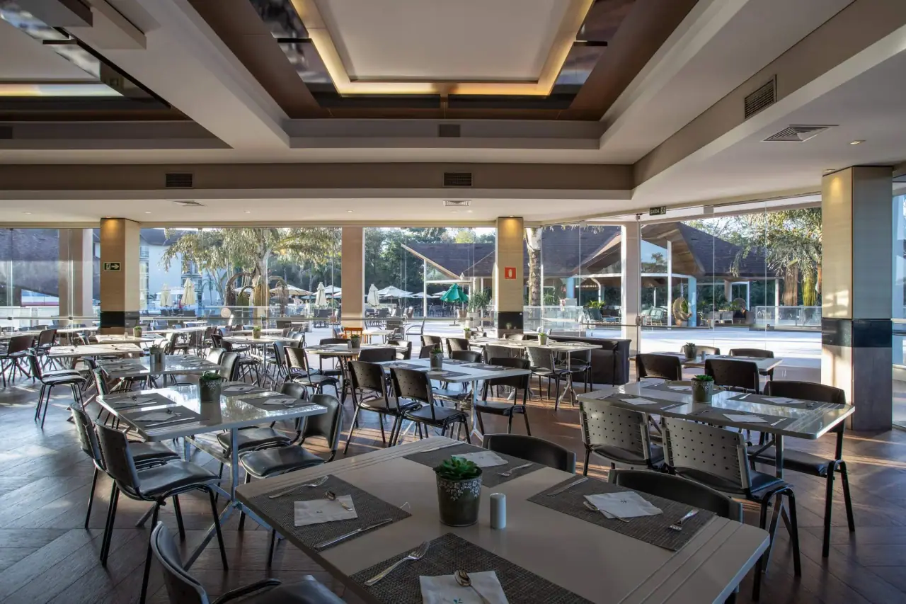 Restaurant dining room with tables and large windows