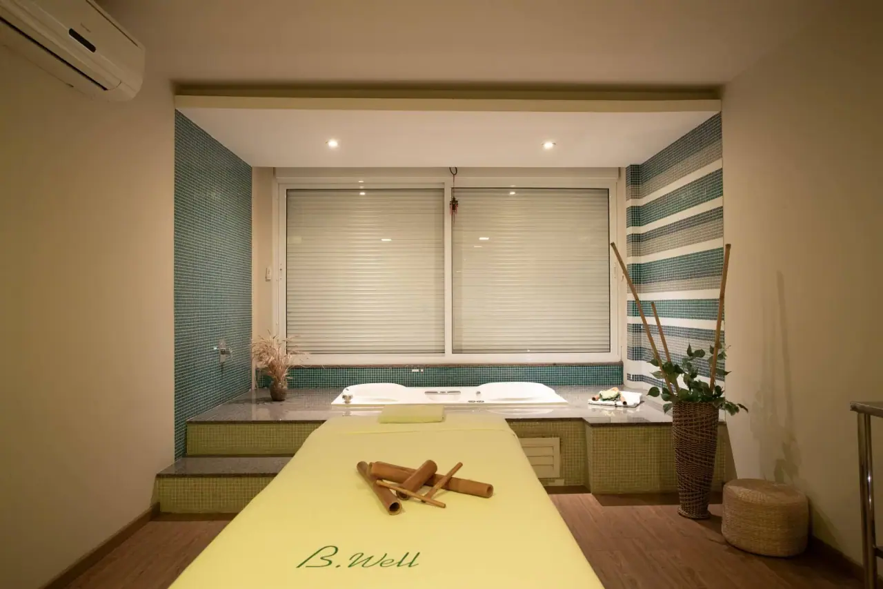 Spa treatment room with massage table and natural decor
